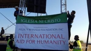 People hanging banner of International Aid for Humanity