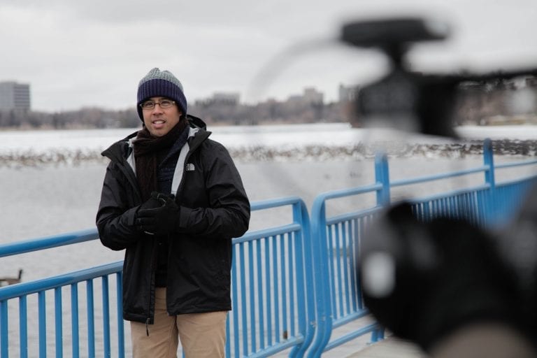 Nan Zapanta in outer winter wear with the city of Regina in the background.