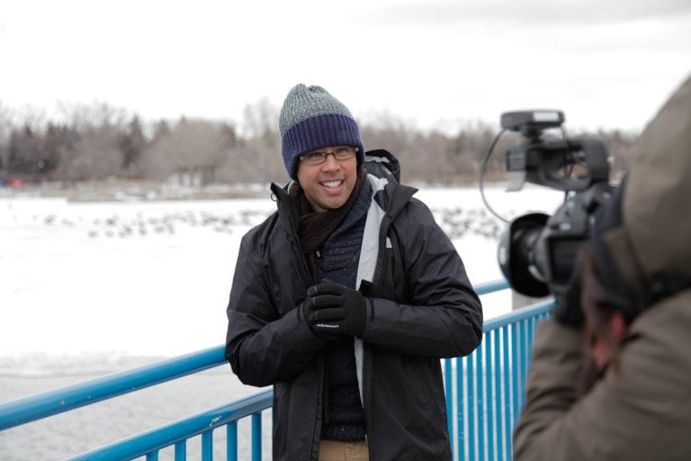 Nan Zapanta in outer winter wear smiling while in front of the camera.