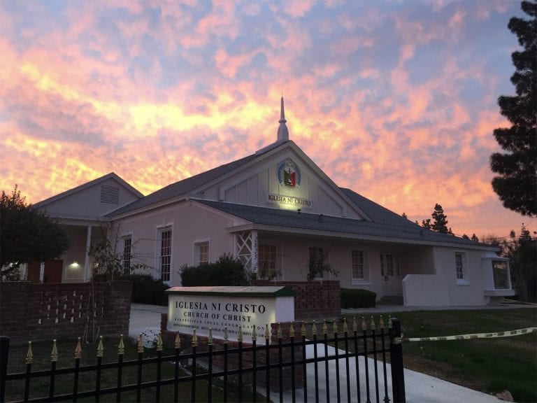 Front exterior of the Bakersfield house of worship with the sunset behind it.