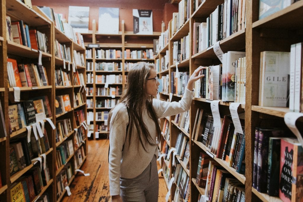 Girl looking at books at bookstore.