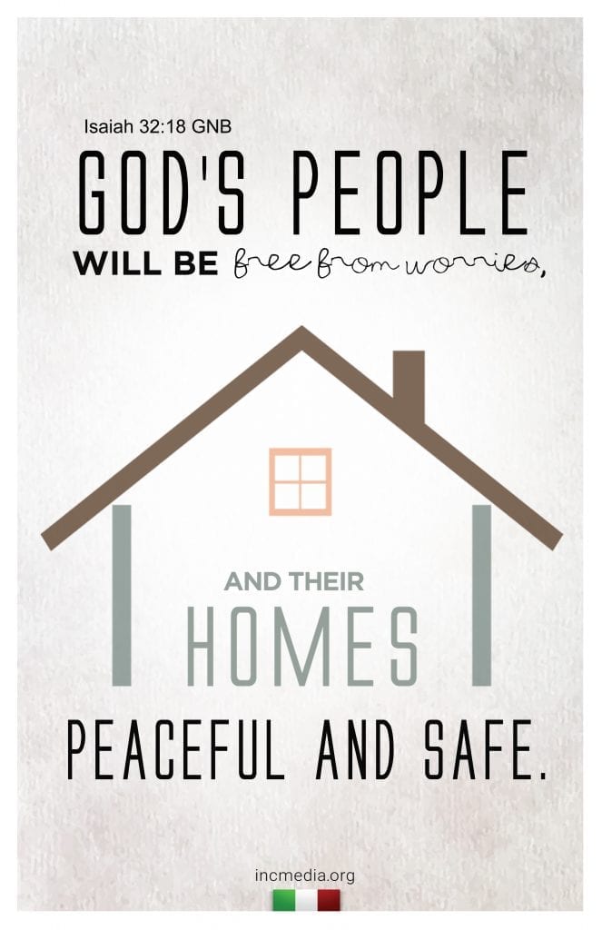 Framed verse Isaiah 32:18 on a wood mantle with decorative brush in a pitcher next to it.