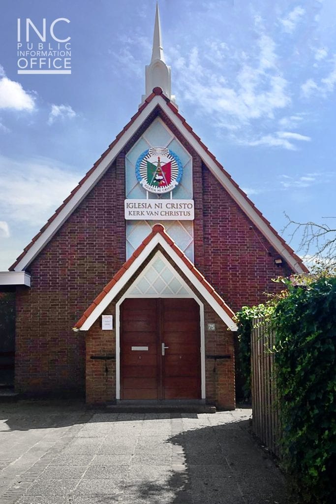 worship building with spire and seal, blue sky
