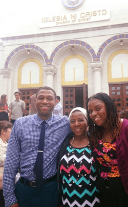 Mom with two kids and people in the background in front of the Washington D.C. worship building.