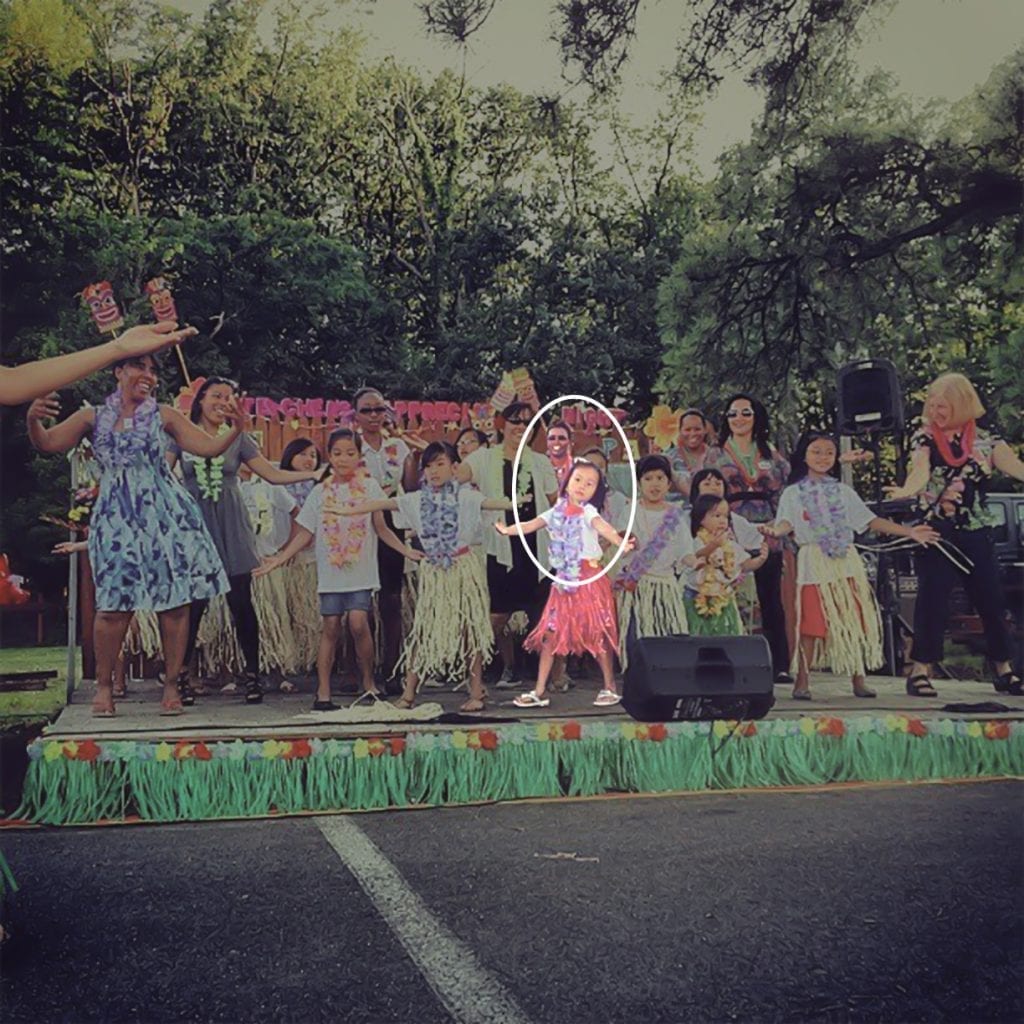 Teachers and children dancing on stage for Teacher Appreciation Day.