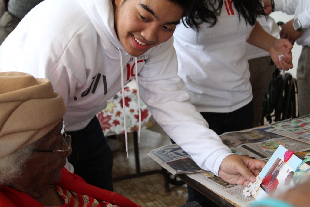 Young man showing a photo an elderly lady.