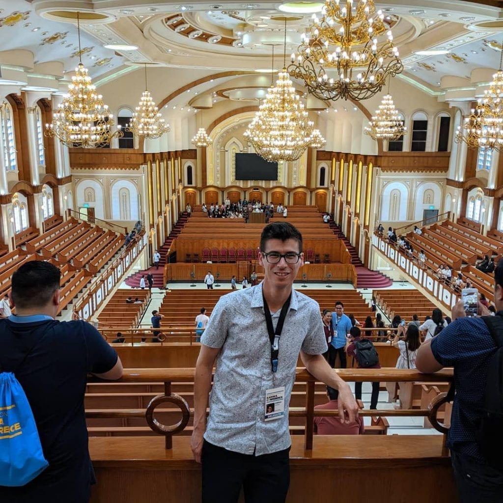 Joshua Yanez posing in the balcony of an Church Of Christ chapel