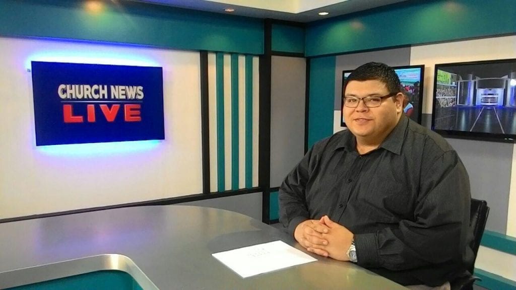 Man sitting at news desk
