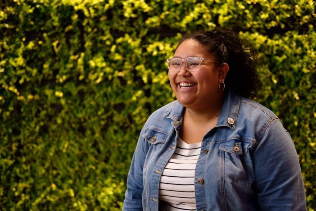Young woman with glasses smiling