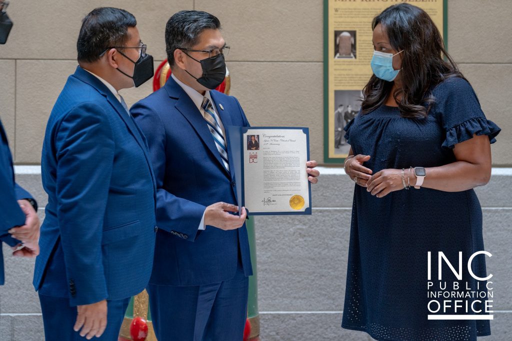 District of Columbia Secretary Kimberly A. Bassett hands over the Mayor’s letter of congratulations to INC Minister, Brother Carlitos Medina.