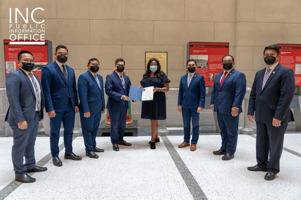 INC Ministers pose with District of Columbia Secretary Kimberly A. Bassett with the congratulatory letter from Washington, D.C. Mayor Muriel Bowser