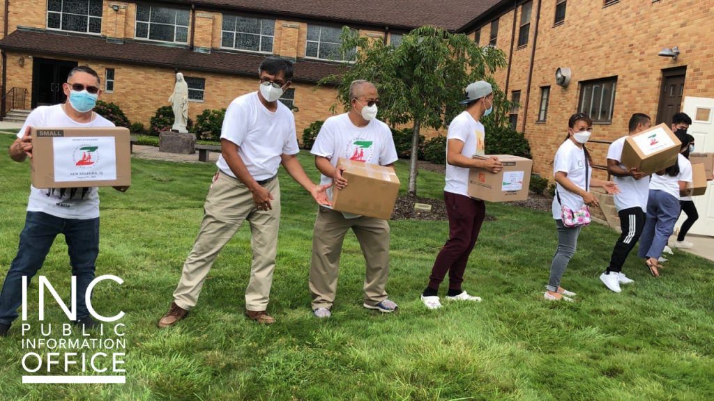 Boxes of food donated by the INC being brought into the Church of the Ascension in New Milford, NJ.