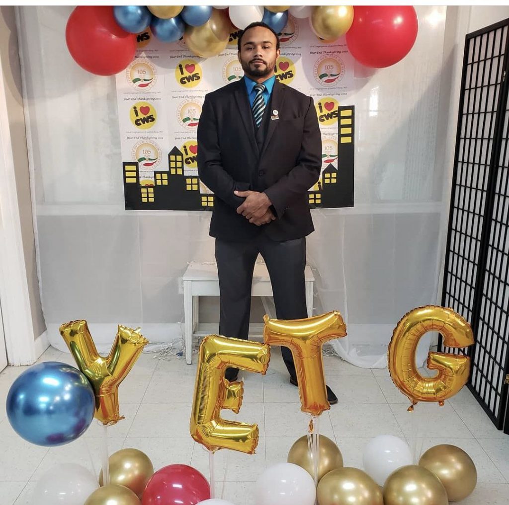 man with balloons spelling YETG