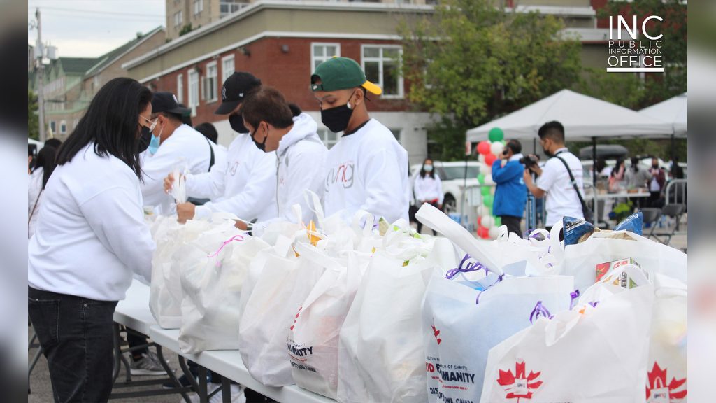 Group of Felix Y. Manalo Foundation volunteers prepare table of free care packages for Gatineau residents Aid To Humanity event of the Iglesia Ni Cristo (Church Of Christ).