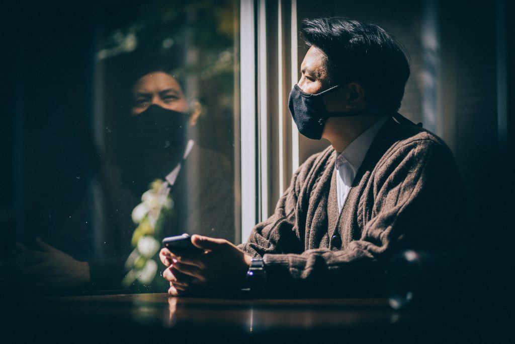 young man thinking and looking out the window