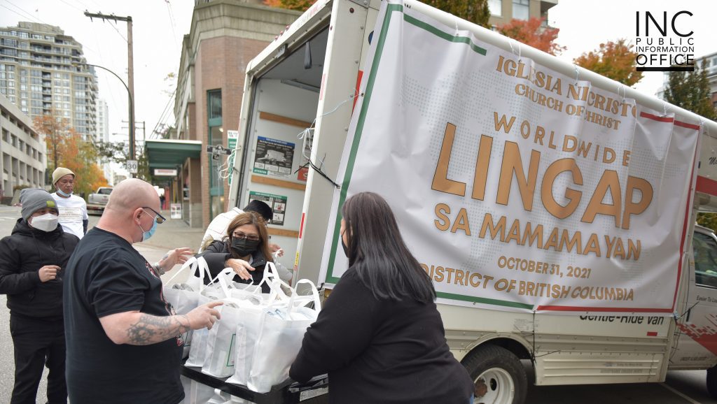 Volunteers of the Felix Y. Manalo Foundation unload care packages from a large U-Haul truck and drop them off to the Lookout Shelter in New Westminster.