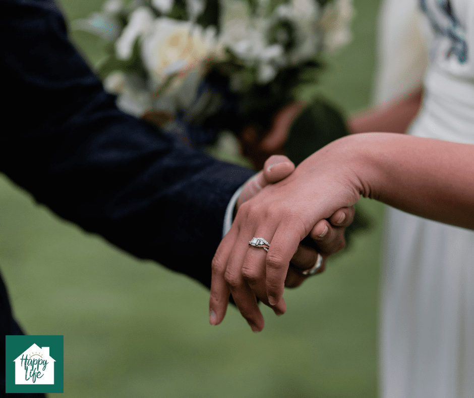 Hands of a newly married couple are seen as the husband takes his wife by her hand
