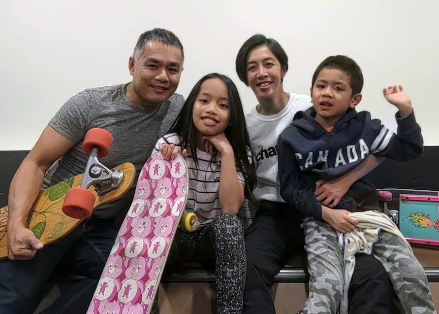 Family of four with skateboards