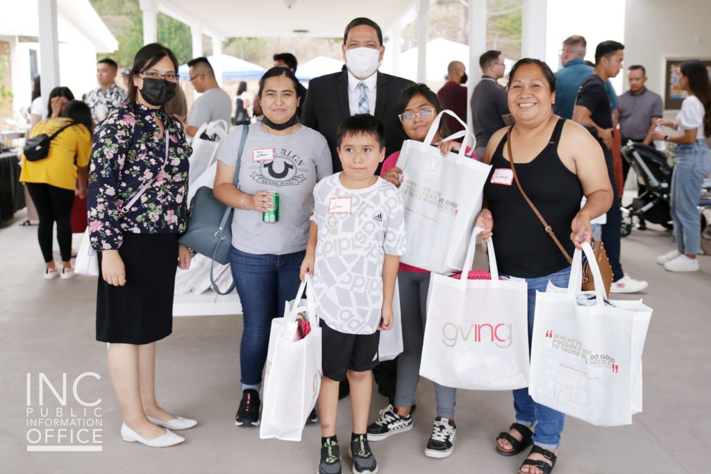 A family receives free care packages with backpacks and school supplies from the Iglesia Ni Cristo, Church Of Christ INC Giving volunteers in Vista at one of eight 108th Anniversary celebrations in San Diego and throughout the world.
