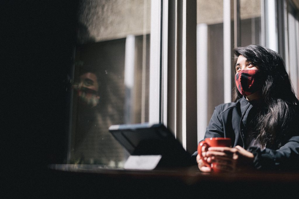 girl staring out from top of stairs