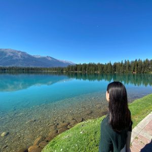 a girl staring into a lake