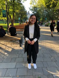 a girl in black and white smiling at camera
