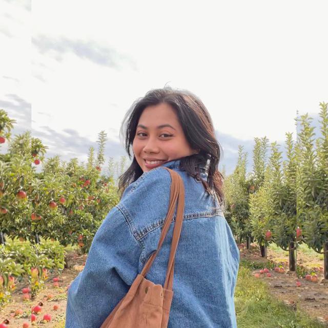 a girl in a jean jacket with head turned