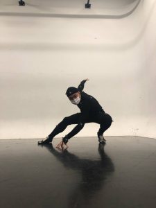 a guy in black posing like spiderman