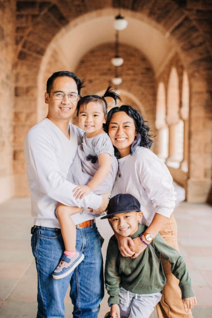 family of four in a stone hallway
