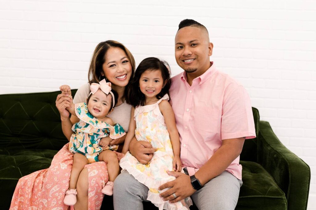 family of four sitting on a couch